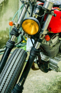 yellow,light,bulb,and,wheel,of,vintage,motercycle